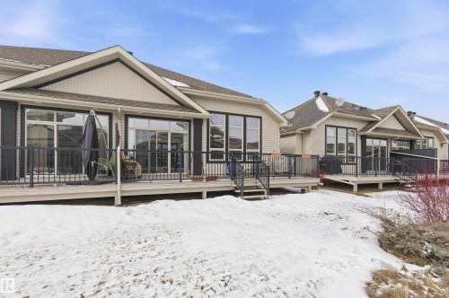 This property features a spacious deck with dark railings, providing an inviting outdoor area - 13 841 156 Street, Edmonton, AB - Outdoor With Deck Patio Veranda
