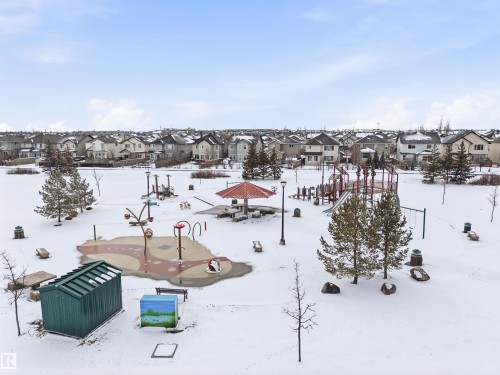 The property is located within a community featuring a playground with slides, swings, and various play structures, as well as a splash pad area - 13 841 156 Street, Edmonton, AB - Outdoor With View