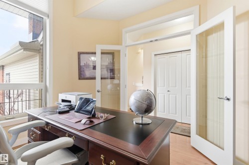 Dedicated office space featuring a large window, light-colored walls, and a desk with storage - 13 841 156 Street, Edmonton, AB - Indoor Photo Showing Office