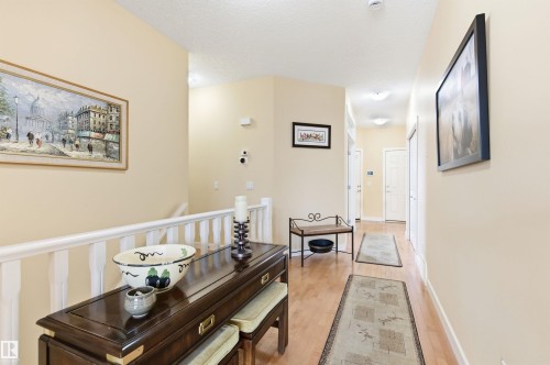 The property features light-toned walls and wood flooring, enhancing the brightness of the interior - 13 841 156 Street, Edmonton, AB - Indoor Photo Showing Other Room