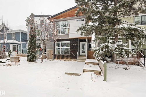 The property features a contemporary exterior with contrasting dark and light facade elements, large windows, and a prominent front entrance with a porch - 10607 127 Street, Edmonton, AB - Outdoor With Facade
