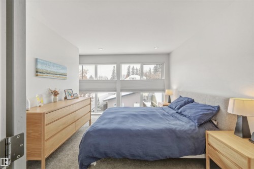 The bedroom features large windows, white walls, and recessed lighting - 10607 127 Street, Edmonton, AB - Indoor Photo Showing Bedroom