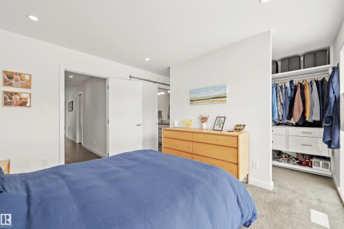 This bedroom features light-colored walls and recessed lighting - 10607 127 Street, Edmonton, AB - Indoor Photo Showing Bedroom