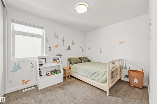 A room featuring a window with a white blind, white walls, and carpeted flooring - 10607 127 Street, Edmonton, AB - Indoor Photo Showing Bedroom