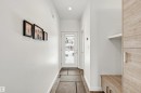 Entryway featuring light-colored flooring, a white door with frosted glass, and built-in storage with a light wood finish - 10607 127 Street, Edmonton, AB  - Indoor Photo Showing Other Room 