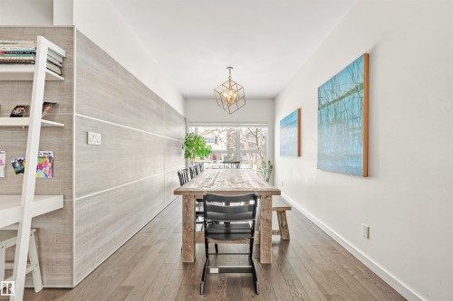 Living area featuring wood flooring, a built-in shelving unit, and a rectangular window - 10607 127 Street, Edmonton, AB - Indoor Photo Showing Other Room
