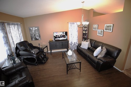 Living area featuring wood-look flooring and a chandelier - 9347 175 Avenue, Edmonton, AB - Indoor Photo Showing Living Room