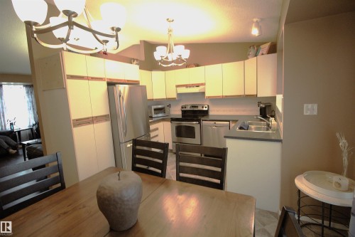 The kitchen features ample cabinetry, stainless steel appliances, and a double basin sink - 9347 175 Avenue, Edmonton, AB - Indoor Photo Showing Kitchen With Double Sink