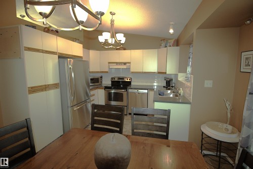 Kitchen with white cabinetry, stainless steel appliances, and a tiled backsplash - 9347 175 Avenue, Edmonton, AB - Indoor Photo Showing Kitchen With Double Sink