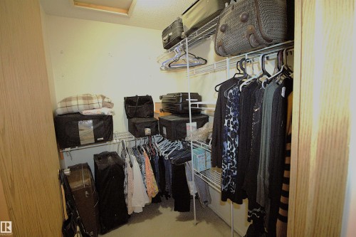 This closet features white wire shelving and hanging rods - 9347 175 Avenue, Edmonton, AB - Indoor With Storage