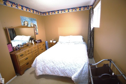 The property features neutral-toned walls, a window with curtains, and a light-colored carpet - 9347 175 Avenue, Edmonton, AB - Indoor Photo Showing Bedroom