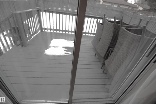 The property includes a spacious outdoor deck with wood flooring and a perimeter railing - 9347 175 Avenue, Edmonton, AB - Indoor Photo Showing Other Room