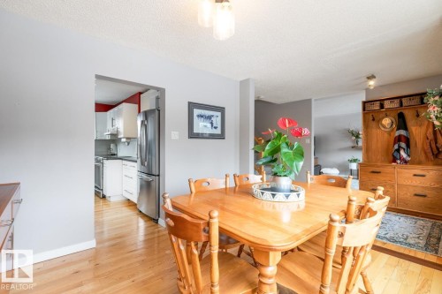 Inviting dining area featuring hardwood floors and a warm wood dining set - 10504 60 Street, Edmonton, AB - Indoor Photo Showing Dining Room