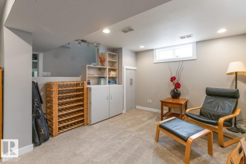 This versatile room features neutral-toned carpeting, recessed lighting, and a window providing natural light - 10504 60 Street, Edmonton, AB - Indoor Photo Showing Basement