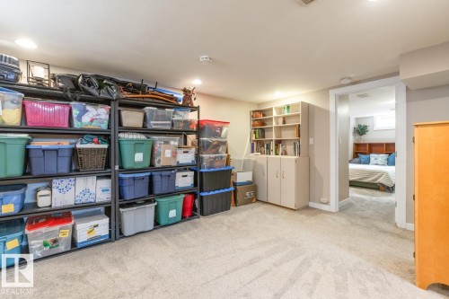 This property features extensive carpeted areas and built-in shelving, providing ample storage solutions - 10504 60 Street, Edmonton, AB - Indoor