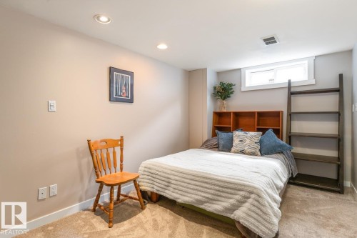 This room features neutral-toned walls, recessed lighting, and carpeted flooring - 10504 60 Street, Edmonton, AB - Indoor Photo Showing Bedroom