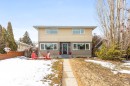 This property features a two-story exterior with light-colored siding and a contrasting darker lower level - 10504 60 Street, Edmonton, AB  - Outdoor 