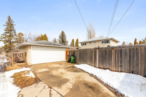 Detached garage with an asphalt shingle roof and a white garage door - 10504 60 Street, Edmonton, AB - Outdoor