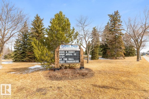 The property is located within a community featuring mature trees, open green spaces, and a nearby paved pathway - 10504 60 Street, Edmonton, AB - Outdoor
