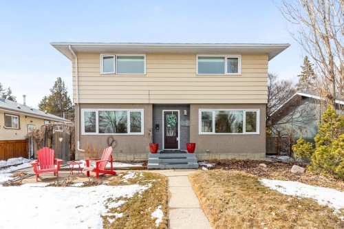 The property features a two-story exterior with light-colored siding on the upper level and a darker-toned lower level - 10504 60 Street, Edmonton, AB - Outdoor