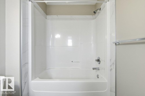 The property features a tub and shower combination with a white surround and chrome fixtures - 2 Wingate Way, Fort Saskatchewan, AB - Indoor Photo Showing Bathroom