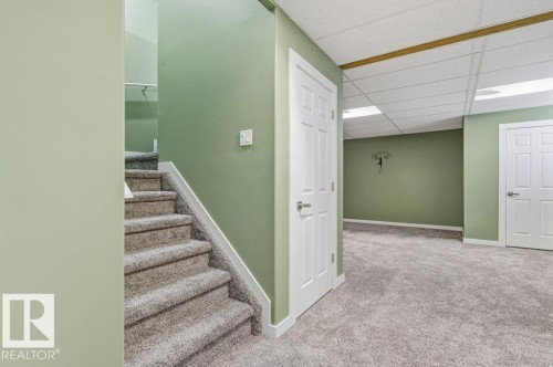 Finished area featuring carpeted flooring, light green walls, and white doors - 2 Wingate Way, Fort Saskatchewan, AB - Indoor
