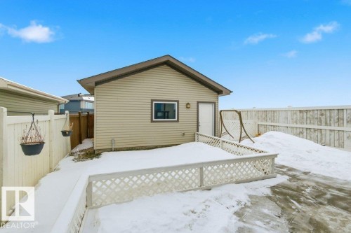 The property features a detached garage with horizontal siding and a side entry door - 2 Wingate Way, Fort Saskatchewan, AB - Outdoor With Exterior