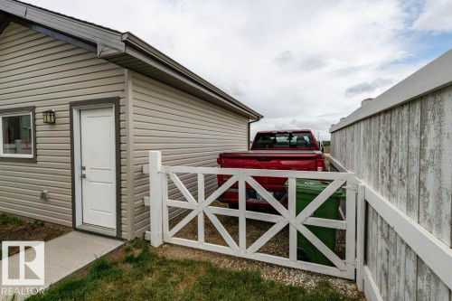 The property exterior features horizontal siding, a window, and an outdoor light fixture - 2 Wingate Way, Fort Saskatchewan, AB - Outdoor With Exterior