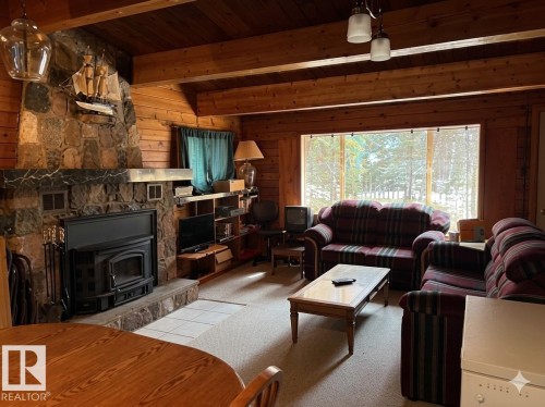 Stone-clad fireplace with a wood-burning insert - 1040 &1040 A&B Mitchell Beach Beach, Rural Leduc County, AB 