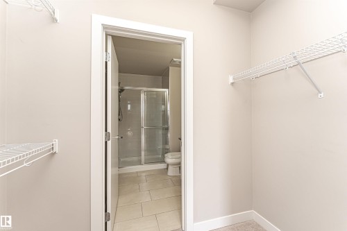 This property features an organized closet area with white wire shelving, providing efficient storage - 313 10418 81 Avenue, Edmonton, AB - Indoor With Storage