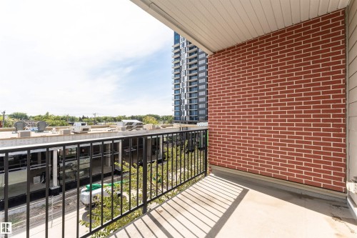 The property features a balcony with a concrete floor and a brick wall - 313 10418 81 Avenue, Edmonton, AB - Outdoor With Balcony With Exterior