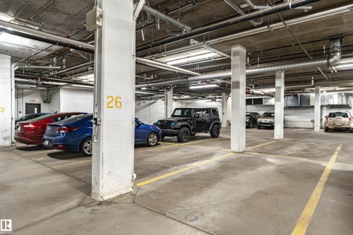 The property includes dedicated parking spaces within a concrete subterranean garage - 313 10418 81 Avenue, Edmonton, AB - Indoor Photo Showing Garage