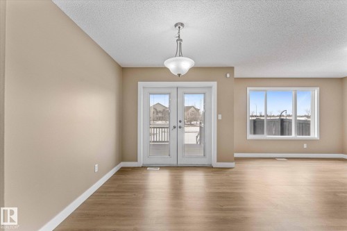 The property features light-toned flooring and neutral wall colors throughout - 84 Calvert Wynd, Fort Saskatchewan, AB - Indoor Photo Showing Other Room