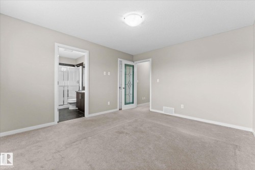 Spacious room featuring light-colored walls and carpeting, with a ceiling light fixture - 84 Calvert Wynd, Fort Saskatchewan, AB - Indoor Photo Showing Other Room