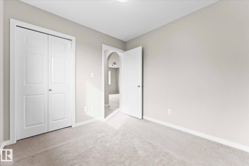 Room featuring light-colored walls, light-colored carpet, and white trim - 84 Calvert Wynd, Fort Saskatchewan, AB - Indoor Photo Showing Other Room