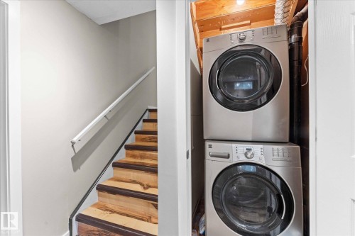 Stacked washer and dryer units located in a dedicated closet - 84 Calvert Wynd, Fort Saskatchewan, AB - Indoor Photo Showing Laundry Room