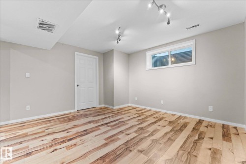 This versatile room features light-colored walls, a white door, and a window providing natural light - 84 Calvert Wynd, Fort Saskatchewan, AB - Indoor Photo Showing Other Room