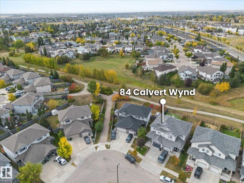 Aerial view of the property and its surrounding neighborhood, showcasing residential homes with grey roofs and paved driveways - 84 Calvert Wynd, Fort Saskatchewan, AB - Outdoor With View