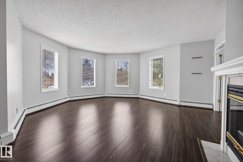 301 9138 83 Avenue, Edmonton, AB - Indoor Photo Showing Other Room With Fireplace