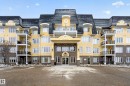 The property features a multi-story building with a distinctive roofline and numerous balconies - 318 9820 165 Street, Edmonton, AB  - Outdoor With Facade 