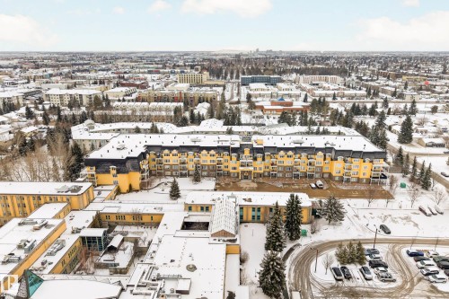 Aerial view showcasing the expansive grounds and the surrounding urban landscape - 318 9820 165 Street, Edmonton, AB - Outdoor With View