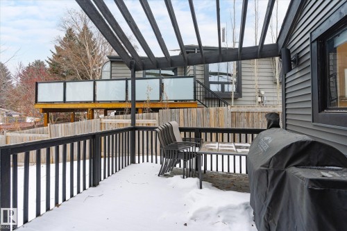The property features a private deck with a dark-stained pergola and railing, offering an outdoor entertaining space - 38 Woodcrest Avenue, St. Albert, AB - Outdoor With Deck Patio Veranda With Exterior