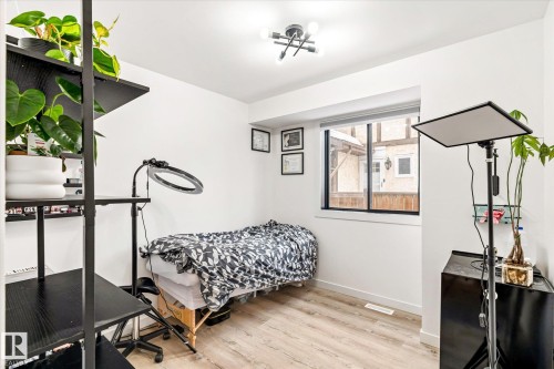 This room features light-toned flooring, white walls, and a window providing natural light - 38 Woodcrest Avenue, St. Albert, AB - Indoor Photo Showing Gym Room