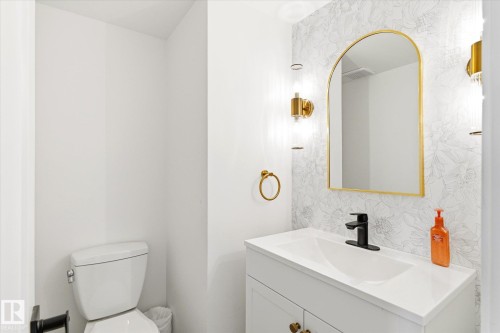 This bathroom features a white vanity with a rectangular sink and a matte black faucet - 38 Woodcrest Avenue, St. Albert, AB - Indoor Photo Showing Bathroom