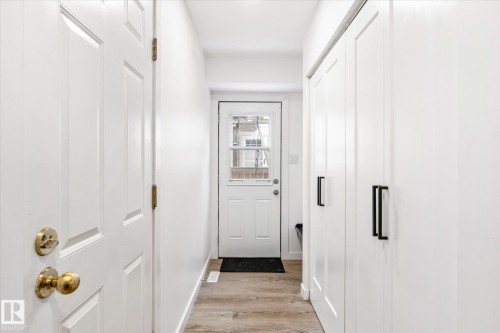Entryway featuring light wood-style flooring, white walls, and a white door with a window - 38 Woodcrest Avenue, St. Albert, AB - Indoor Photo Showing Other Room