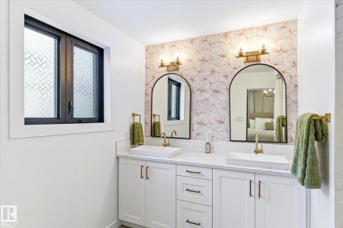 Bathroom featuring a double vanity with white cabinetry, gold-toned hardware, and two arched mirrors - 38 Woodcrest Avenue, St. Albert, AB - Indoor Photo Showing Bathroom