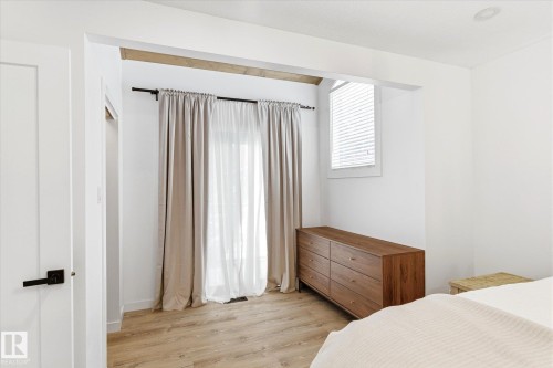 This room features light-colored flooring, a window with blinds, and white walls - 38 Woodcrest Avenue, St. Albert, AB - Indoor Photo Showing Bedroom