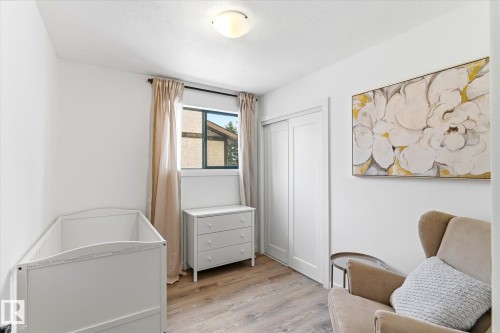 The property features a bright room with light-toned walls, a window with curtains, and wood-look flooring - 38 Woodcrest Avenue, St. Albert, AB - Indoor