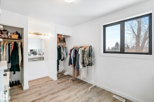 This room features light-toned flooring, white walls, and a window with a dark frame - 38 Woodcrest Avenue, St. Albert, AB - Indoor Photo Showing Other Room