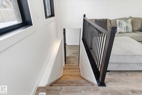 Staircase featuring light-toned flooring, white walls, and a black railing - 38 Woodcrest Avenue, St. Albert, AB - Indoor Photo Showing Other Room